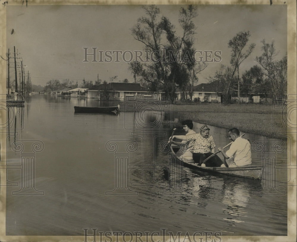 1965 Flood - William Perrott shuttles neighbors in flood waters. - Historic Images