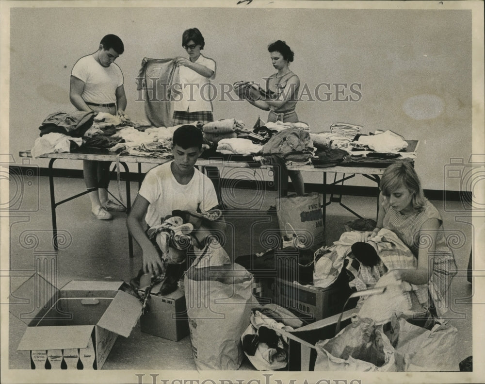 1965 Teen Volunteers Sort Clothes for Hurricane Betsy Victims, NOLA - Historic Images