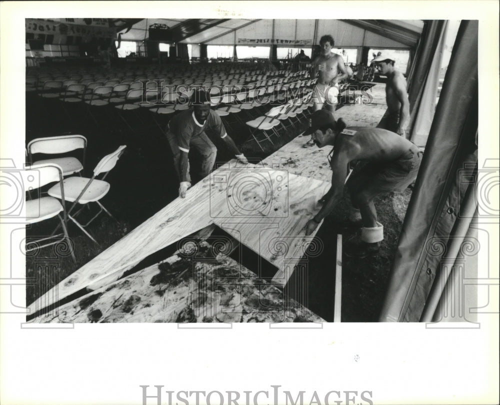 1991 New Orleans Jazz Festival - Workers lay plywood walkway in tent - Historic Images