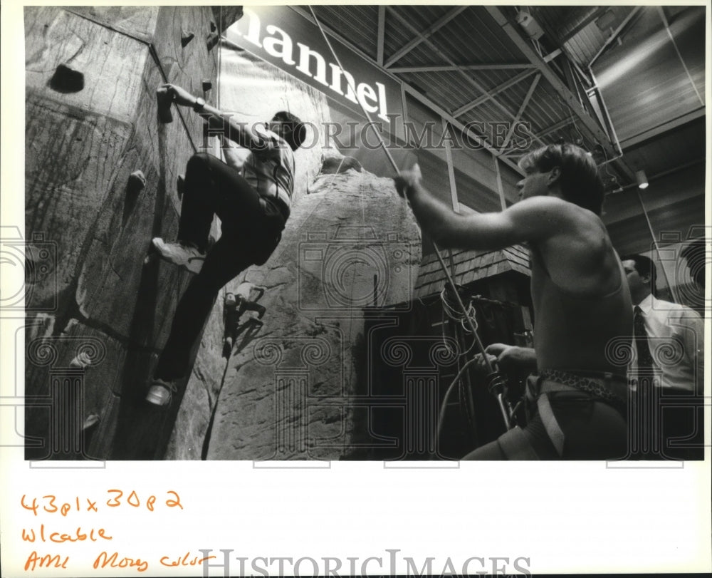 1994 National Cable Television Convention - Cliff Rowzee climbs wall - Historic Images