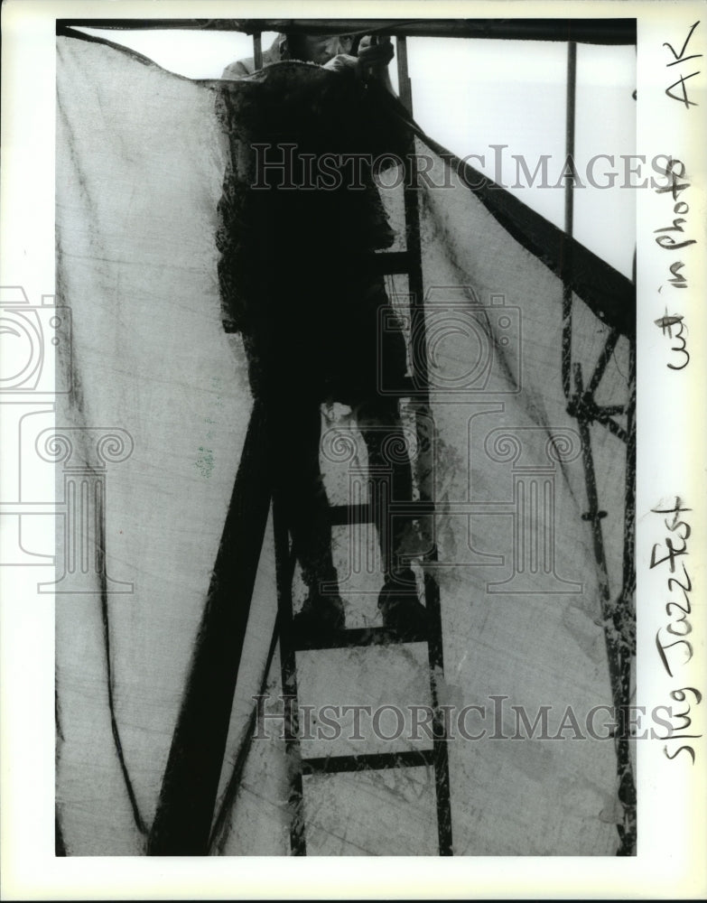 1993 Man Puts UP Plastic on Tent to Block Rain for Jazz Fest, NOLA - Historic Images