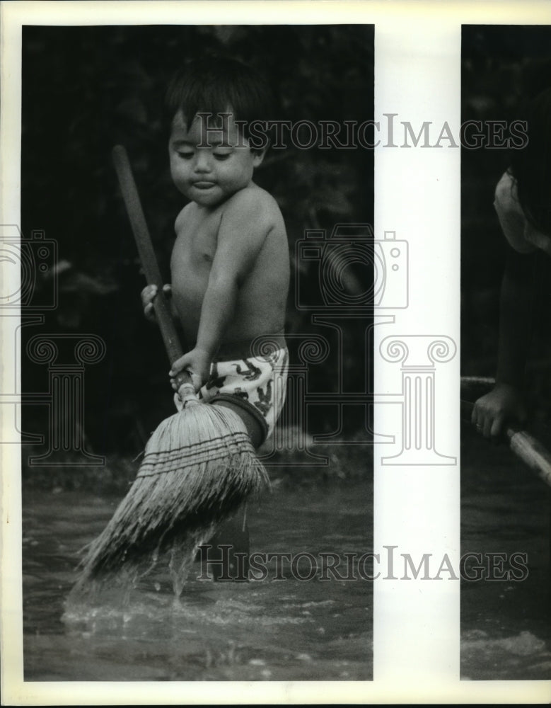 1988 Hurricane Gilbert - Juan Jose sweeps water in Brownsville, TX. - Historic Images