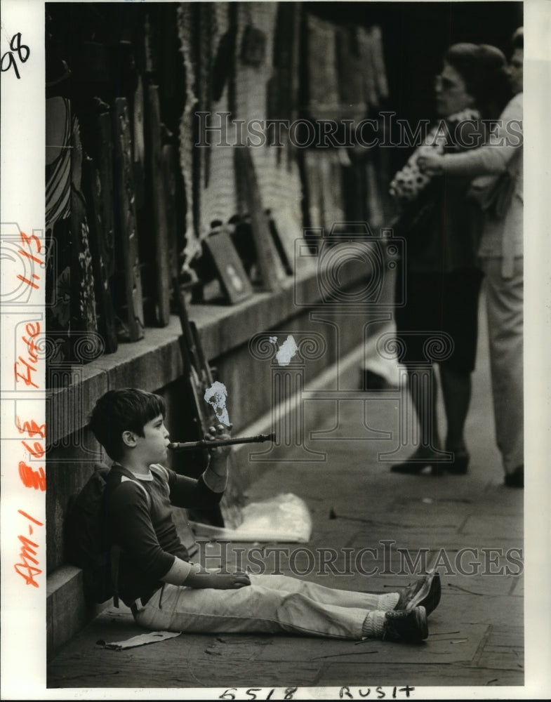 1980 Jackson Square - A young musician sits on St. Peter Street. - Historic Images