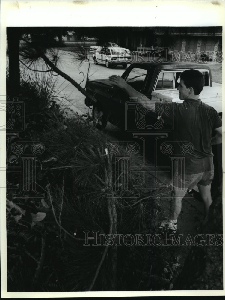 1992 Hurricane Andrew-Keith Rodrigue throws limb atop pile of debris - Historic Images