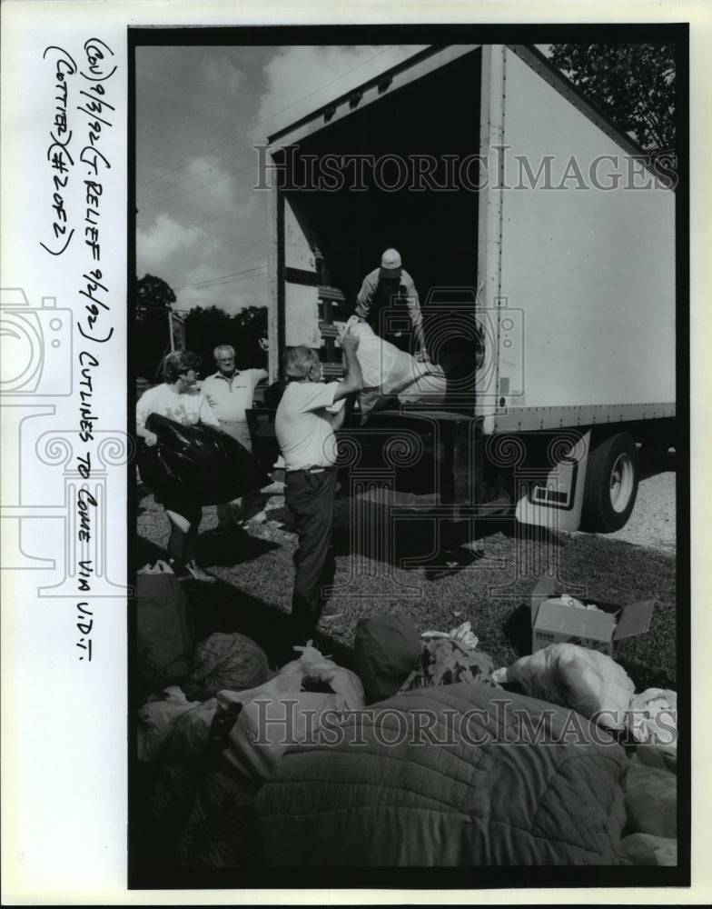 1992 Hurricane Andrew- Relief supplies being loaded into truck. - Historic Images