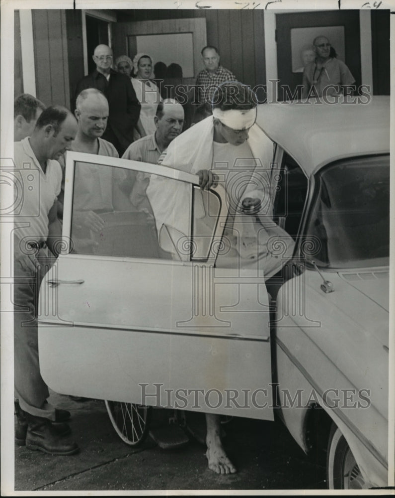 1964 Gary Angelle stepping into car in Larose - Historic Images