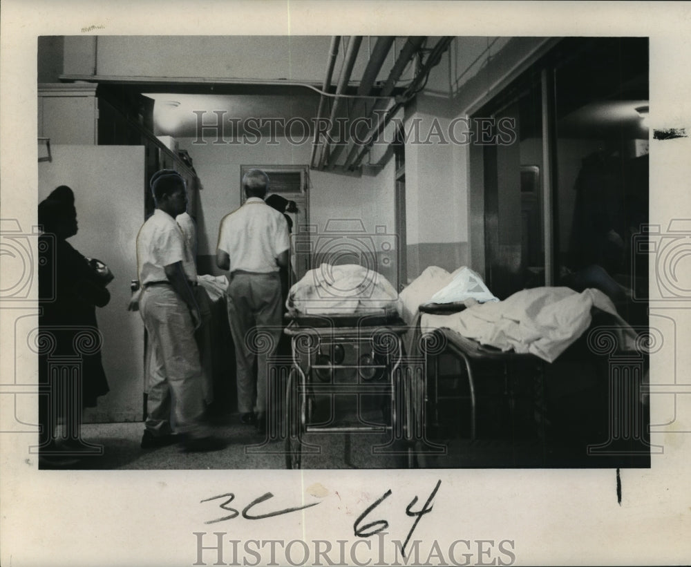 1965 Hurricane Betsy- Silent procession in Orleans Parish morgue. - Historic Images