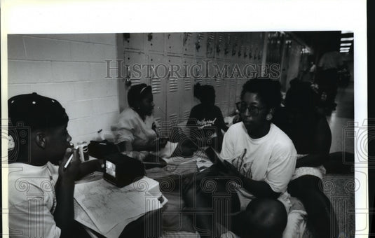 1992 Hurricane Andrew - Metairie residents listen to radio and TV. - Historic Images