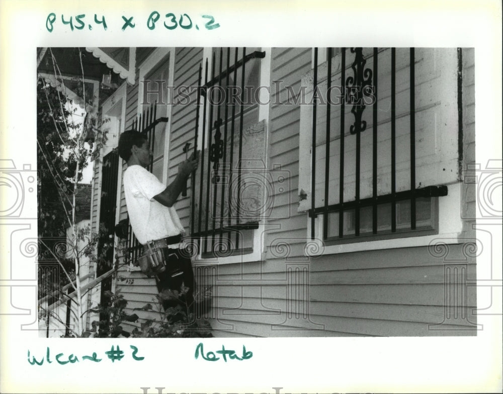 1992 Hurricane Andrew - Jesus Mitry helps board up his sister&#39;s home-Historic Images