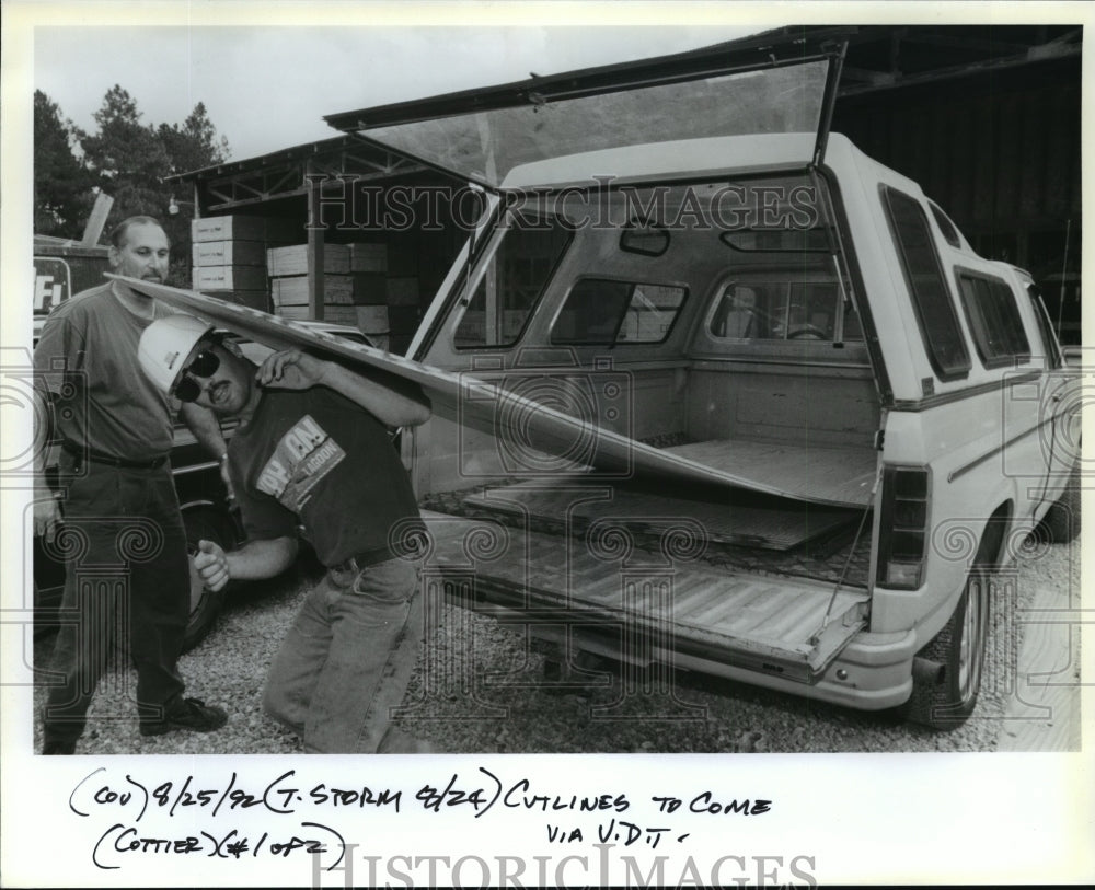 1992 Hurricane Andrew - People load plywood to prepare for storm. - Historic Images