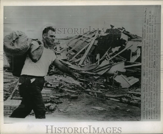 1964 Press Photo Hurricane Hilda, Hubert Theriot of LaRose La. carrying bag.- Historic Images