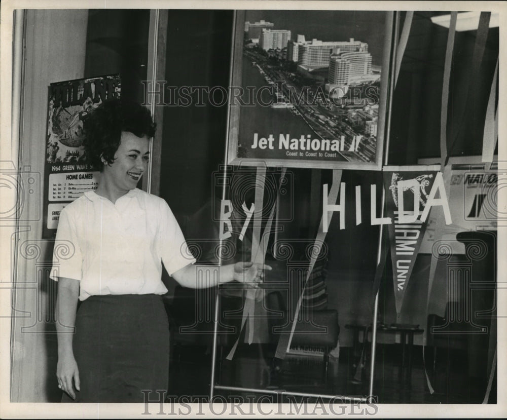 1964 Women Poses Next to Window Sign, Hurricane Hilda  - Historic Images