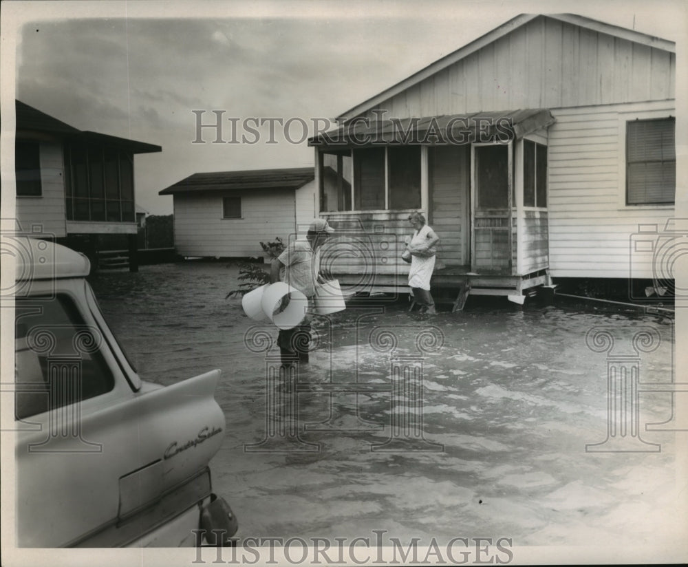 1964 Mr. and Mrs H. H. Engler Leave Flooded House After Storm - Historic Images