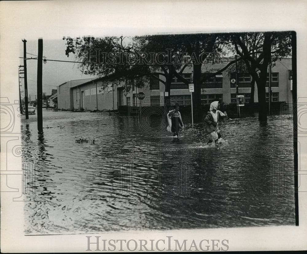 1965 People Wading Through Flooded Streets After Hurricane Betsy - Historic Images