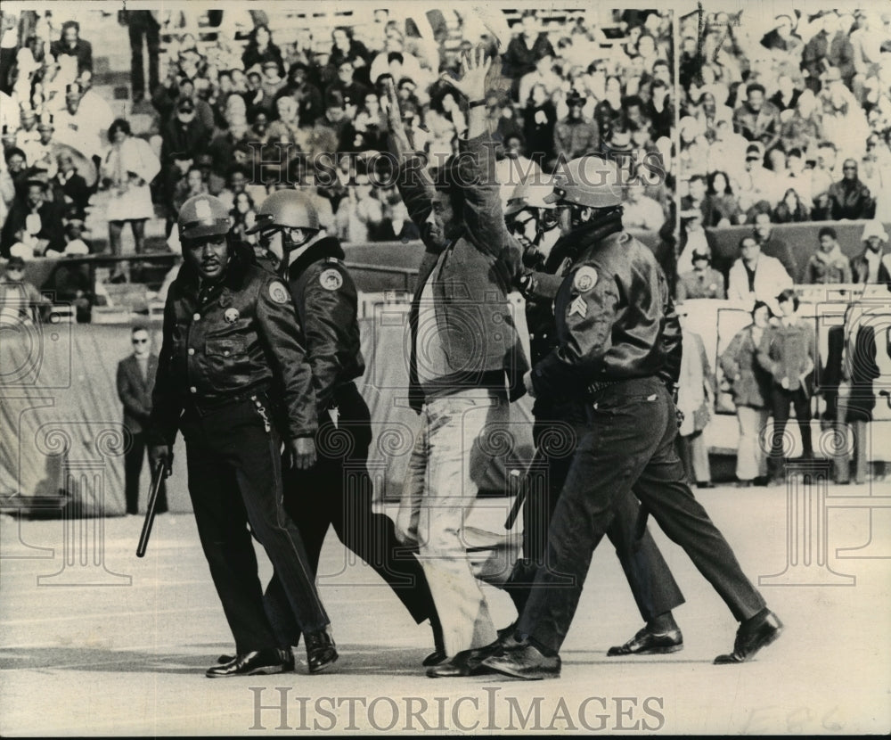 1972 New Orleans Saints game fan escorted from the field - Historic Images