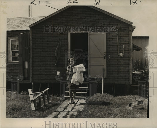 1965 Hurricane Betsy - Mrs. Henry Lee leaves Grand Isle home. - Historic Images