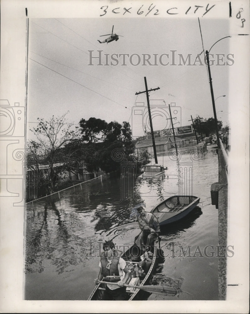 1965 Hurricane Betsy- Rescue workers paddle down St. Claude Ave. - Historic Images