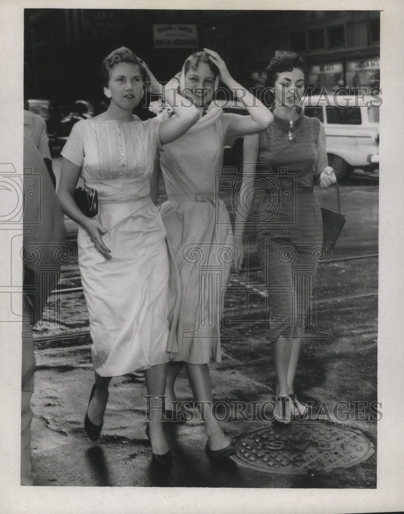 1957 Hurricane Audrey- Women getting windblown. - Historic Images