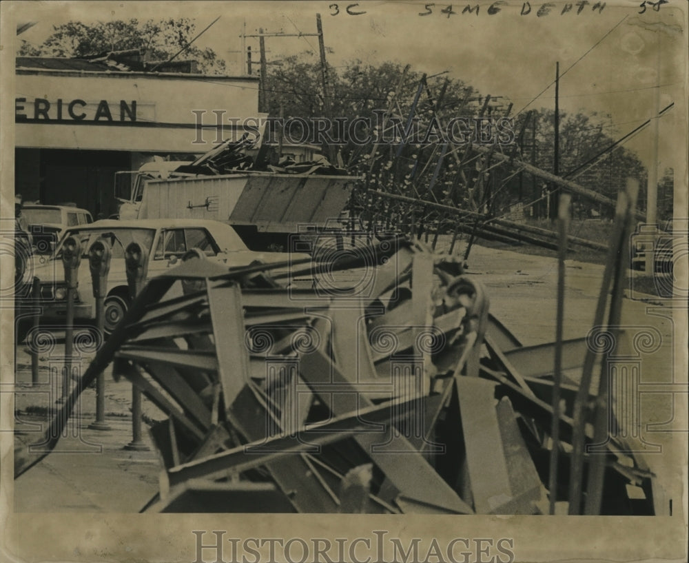 1964 Hurricane Hilda-telephone poles tilt and awnings twisted. - Historic Images