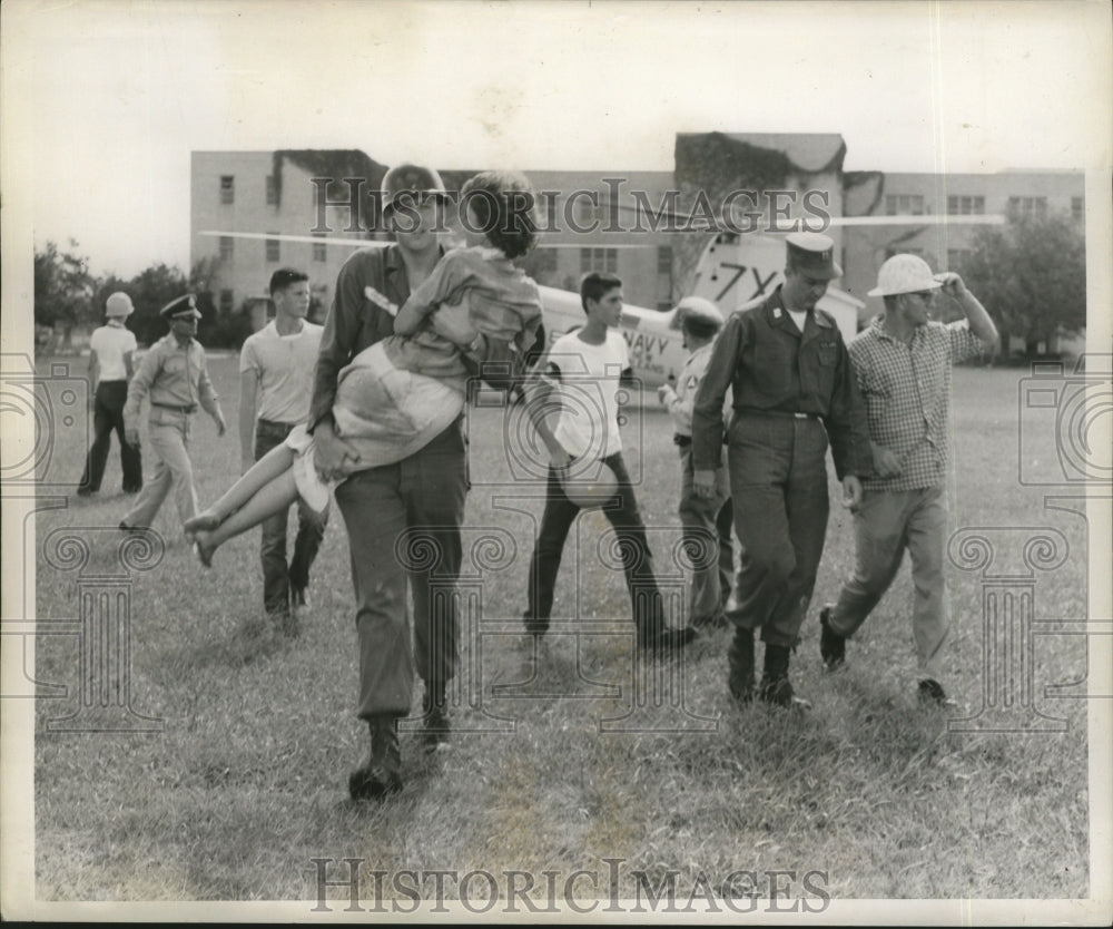 1957 Hurricane Audrey- Rescue workers evacuate victims. - Historic Images