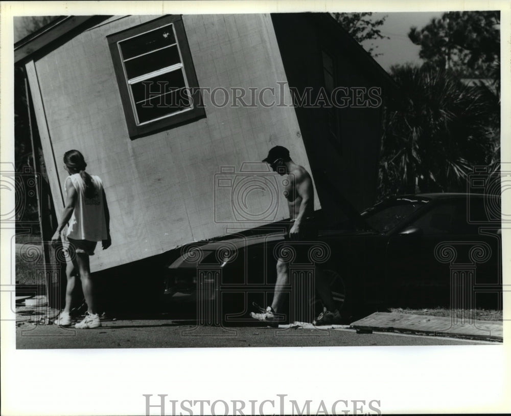 1995 Hurricane Opal- Building rest atop a car. - Historic Images