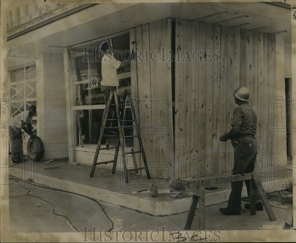 1964 Hurricane Hilda-Service station operator boards up windows. - Historic Images