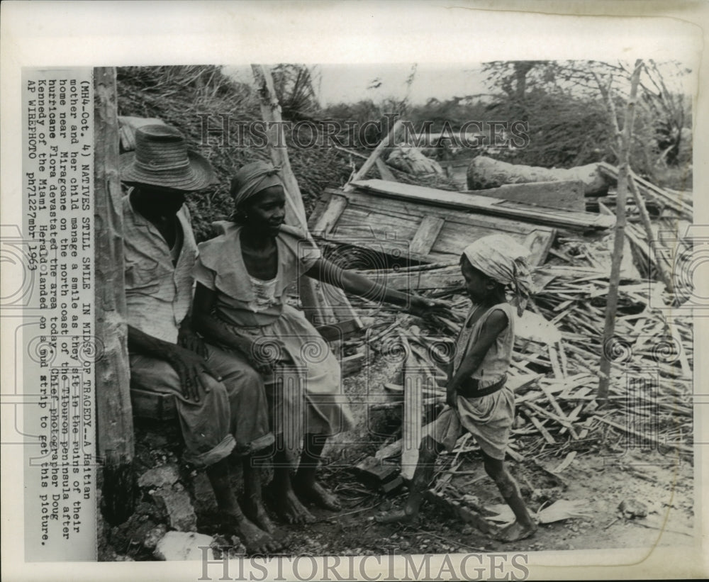1963 Press Photo Haitian mother and child smile in ruins after Hurricane Flora - Historic Images