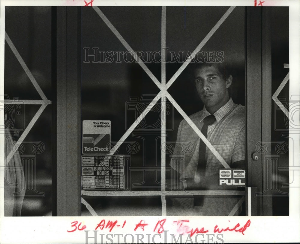 1985 Hurricane Elena - Scott Hanna Looks Thru Taped Window at Shop - Historic Images