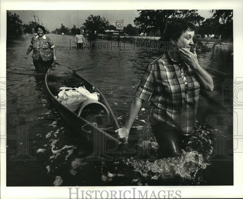 1985 Hurricane Juan-Anna Fulmer wipes rain from her face. - Historic Images