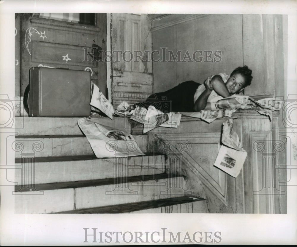 1956 Hurricane Flossy- Man and his belongings take refuge. - Historic Images