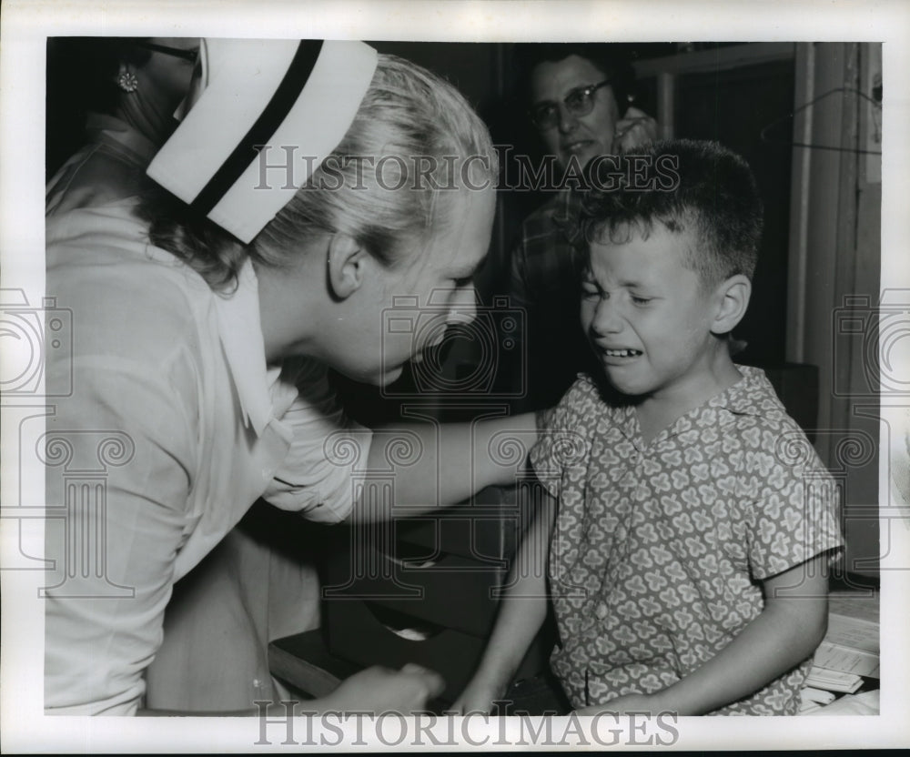 1956 Press Photo Hurricane Flossy- Nurse comforts crying boy. - noa05139- Historic Images