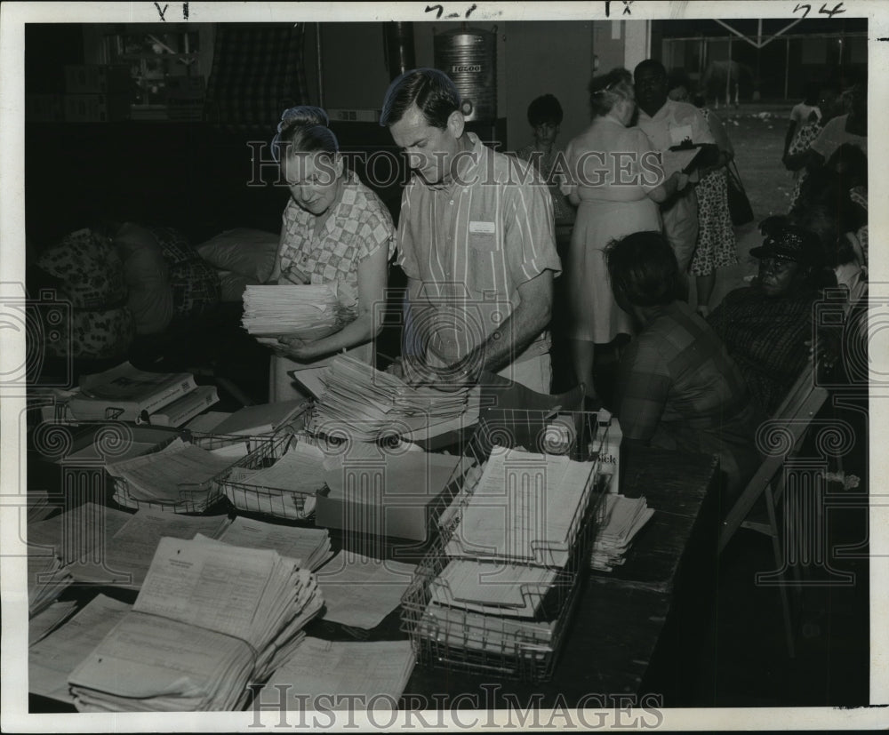 1965 Hurricane Betsy- Ed Cryer and Miss Helen Wills sort papers. - Historic Images