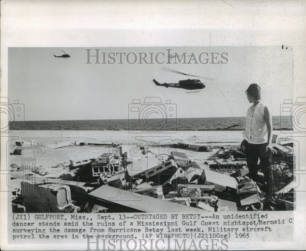 1965 Hurricane Betsy-Unidentified dancer stands amid ruins of Club. - Historic Images