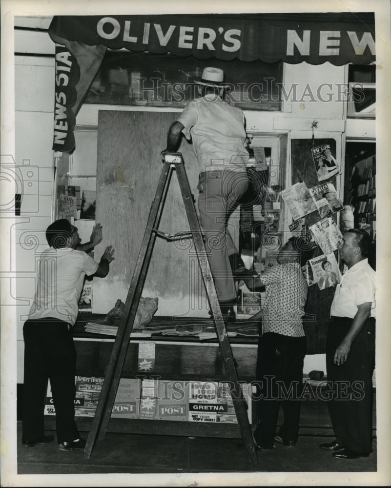 1960 Hurricane Ethel-boarding up windows at Oliver&#39;s News Stand. - Historic Images