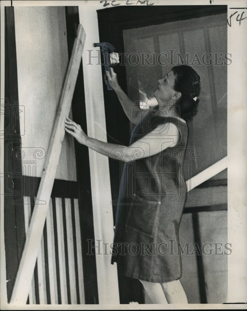 1964 Hurricane Hilda- Mrs. Mickey Harris swings a hammer. - Historic Images