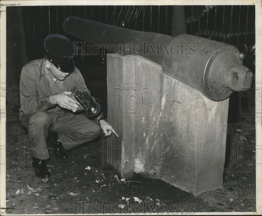 1961 New Orleans Jackson Square- Inspecting damage to cannon. - Historic Images