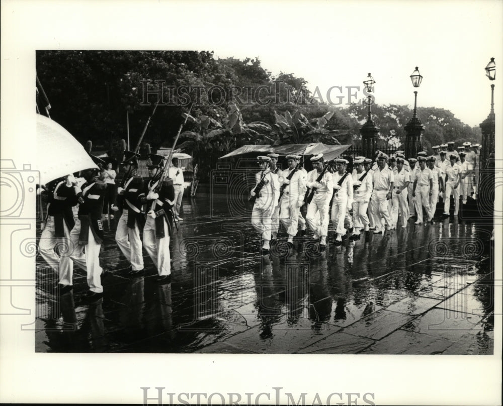 1965 New Orleans- Acadians march in rainy parade. - Historic Images