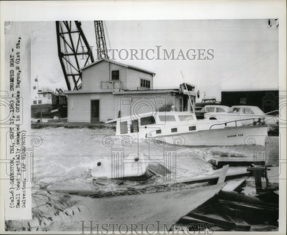 1963 Hurricane Cindy-Small boat partially swamped in Offates Bayou. - Historic Images