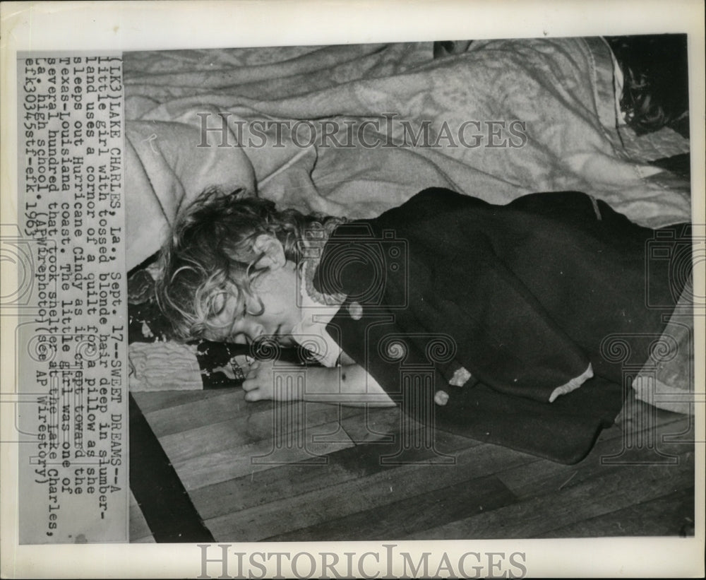 1963 Hurricane Cindy- A little girl with tossed blond hair sleeps. - Historic Images