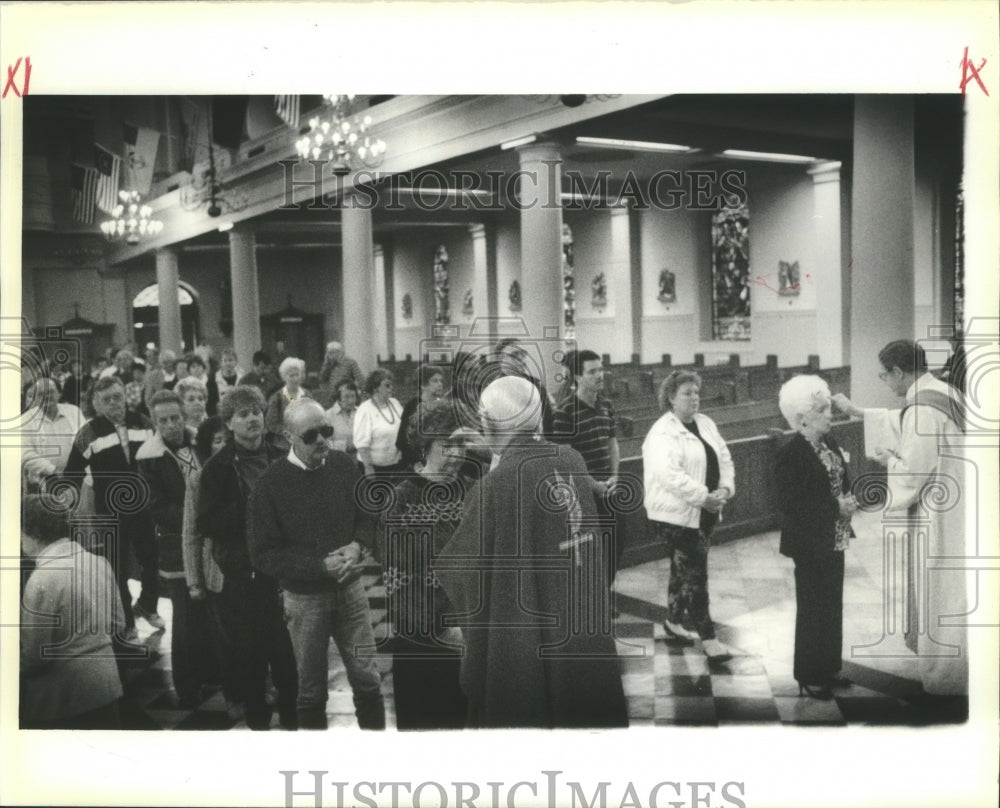 1980 Father Patrick O&#39;Brien and Father Ray Wilhelm dispense ashes. - Historic Images