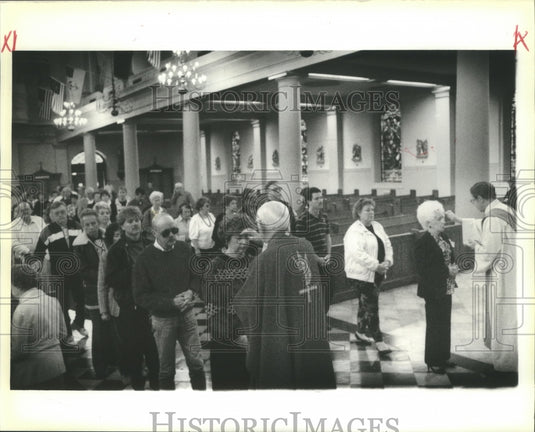 1980 Father Patrick O'Brien and Father Ray Wilhelm dispense ashes. - Historic Images
