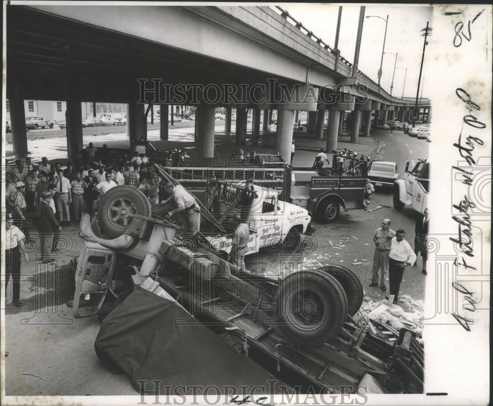 1969 Press Photo Flatbed truck lies upside down after plunging 50 feet. - Historic Images