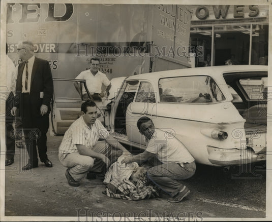1966 Accidents- Passersby comfort Clyde Richardson, 53. - Historic Images