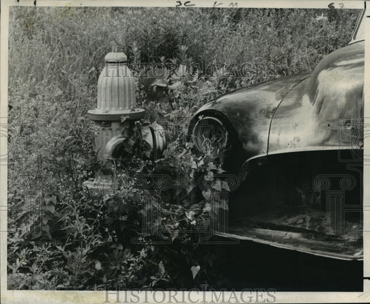 1966 Abandoned car by weedy lot at Coliseum and Urania. - Historic Images