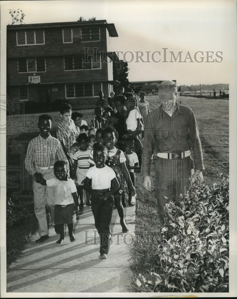 1965 Hurricane Betsy New Orleans survivors follow PFC Derlak to chow - Historic Images