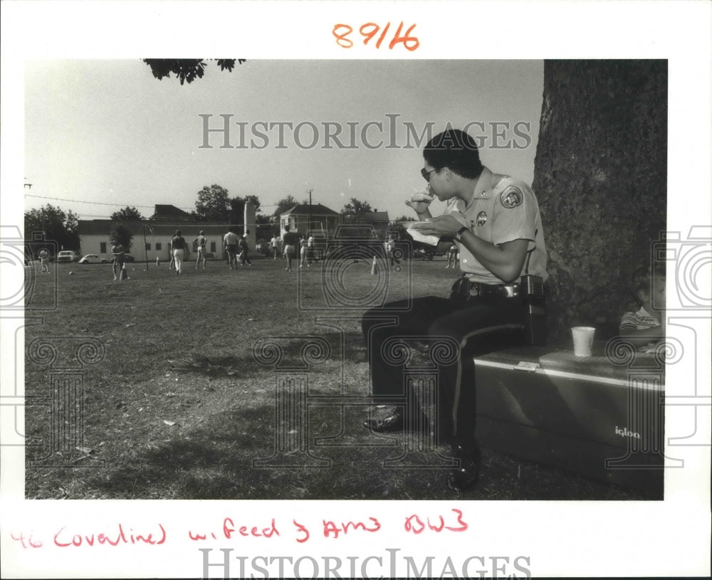 1987 Officer Steven Andry Eating in Algiers Point Park - Historic Images