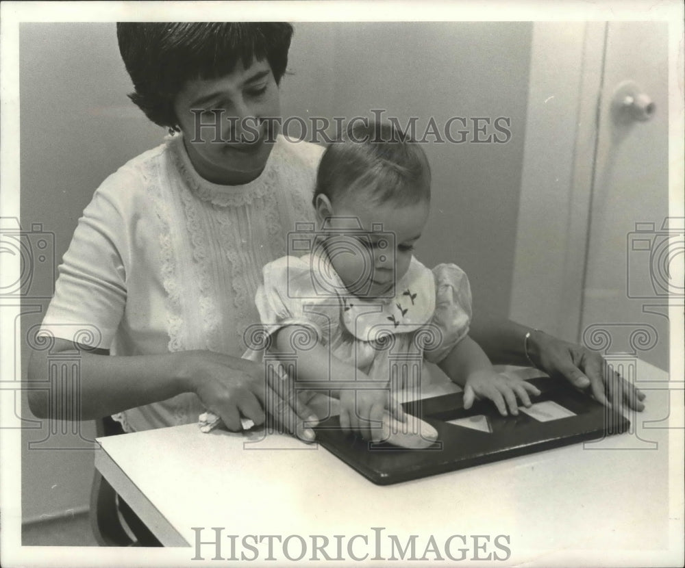 1967 Infant Girl Attempting to Match Shapes in Test - Historic Images