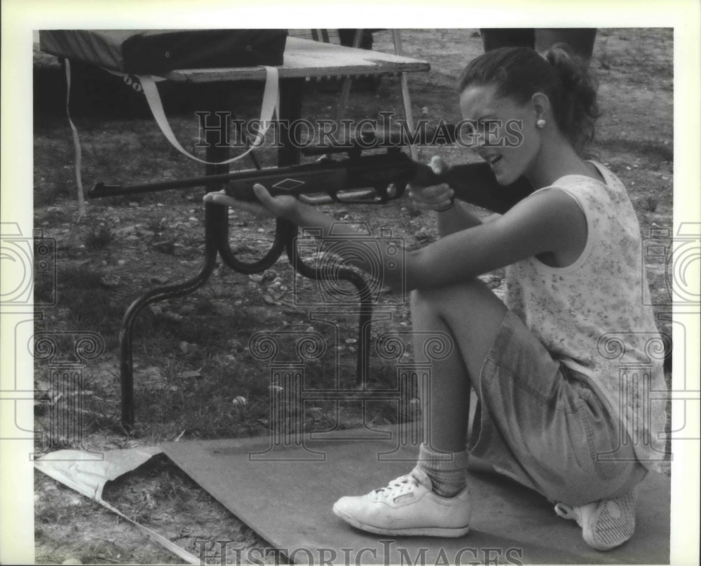 1990 Tasha Cooper fires air rifle at Cajun Triathlon in Eden Isles. - Historic Images