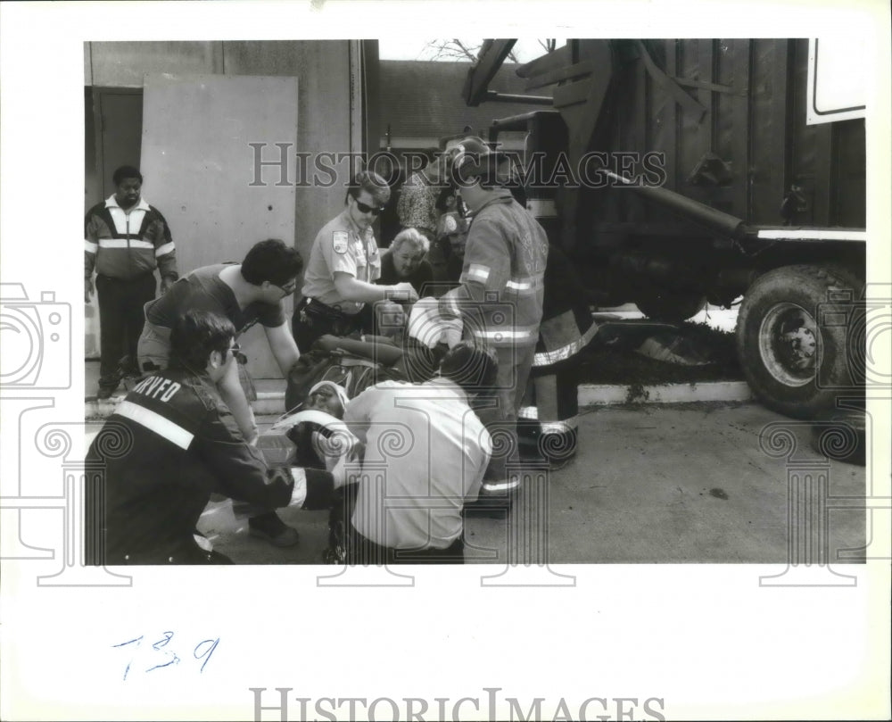 1993 Accidents - Fire and rescue crews help victim David Webb. - Historic Images