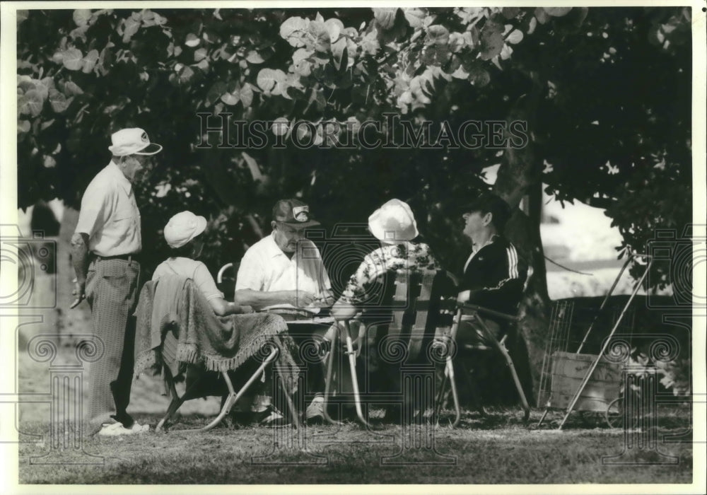 1989 Group of Elderly People Enjoy a Card Game in Florida Beach - Historic Images